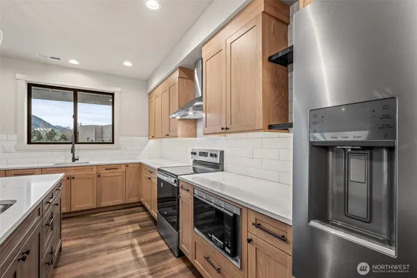 a kitchen with a sink stove and cabinets