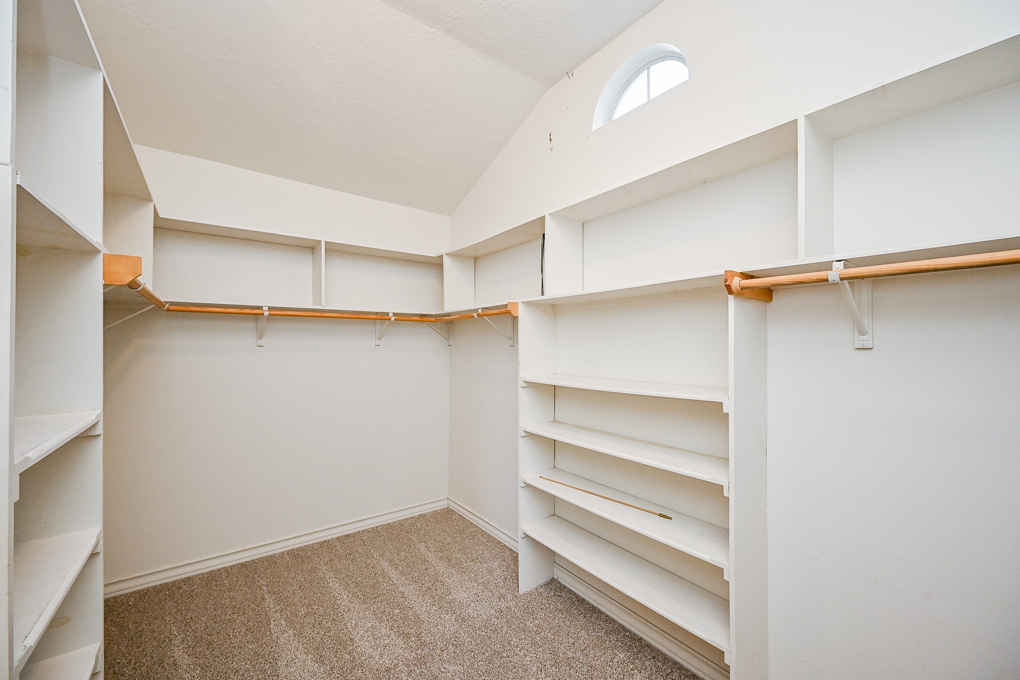 26824 Victory Lane Spring, TX 77386 - Photo 14 of 27 a view of walk in closet with empty racks