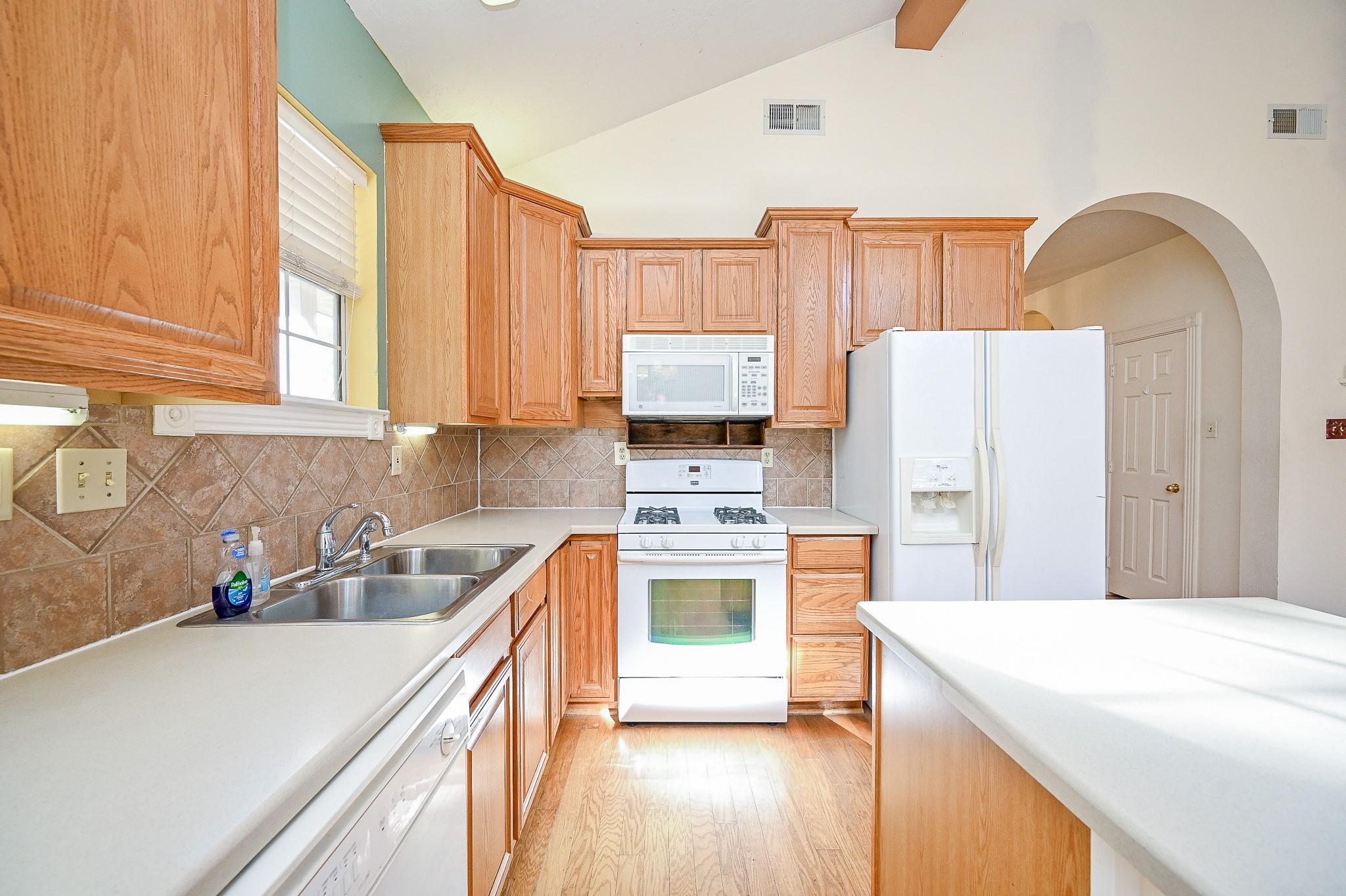 26824 Victory Lane Spring, TX 77386 - Photo 5 of 27 a kitchen with stainless steel appliances a refrigerator sink and cabinets