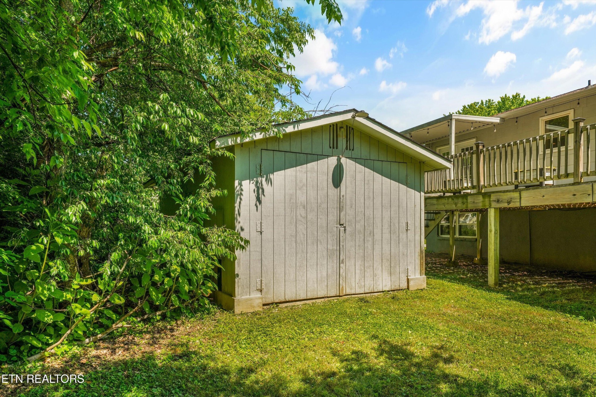 7613 Fall Wind Court Powell, TN 37849 - Photo 33 of 38 a blue house with a small yard and large trees