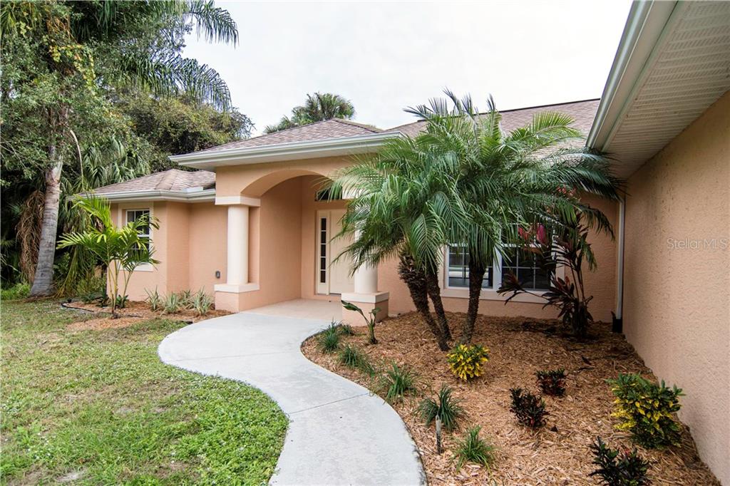 1622 Rada Lane North Port, FL 34288 - Photo 1 of 1 Lush landscaping adorns the walkway to your new home!