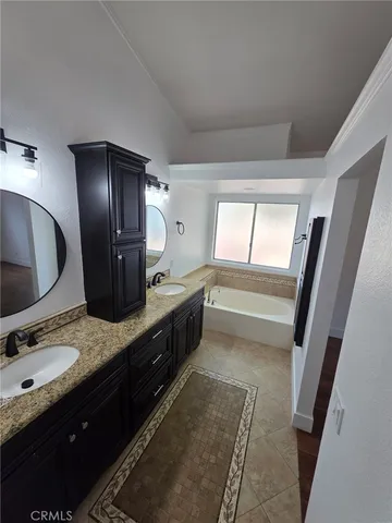 a kitchen with granite countertop a refrigerator and a sink