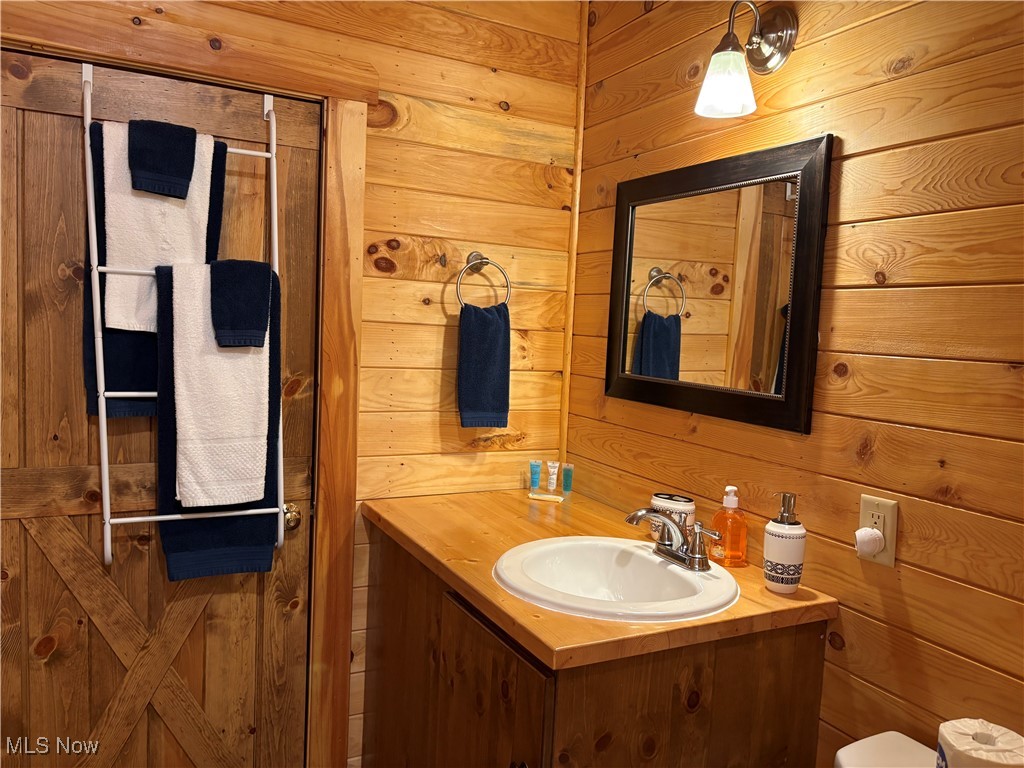 5919 Lake Road West, Unit 18 Ashtabula, OH 44004 - Photo 15 of 32 Bathroom with wooden walls and vanity