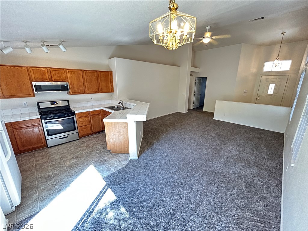 1840 Montvale Las Vegas, NV 89134 - Photo 8 of 31 An open concept design seamlessly connects the efficient kitchen to a carpeted living space.
