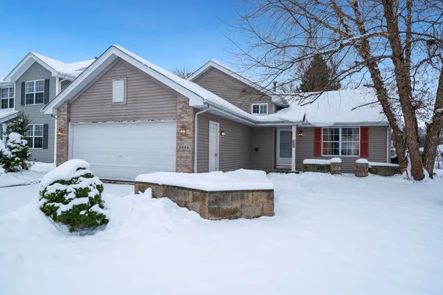 a front view of a house with a yard and a garage