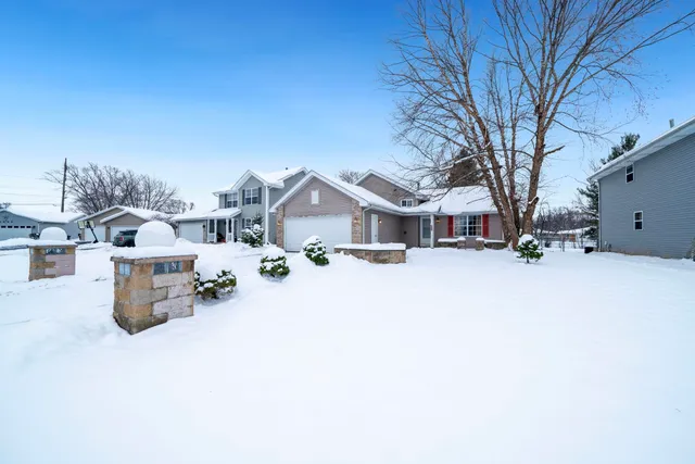 a view of a house with snow on the road