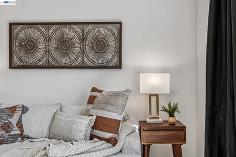a living room with furniture and a wall painting