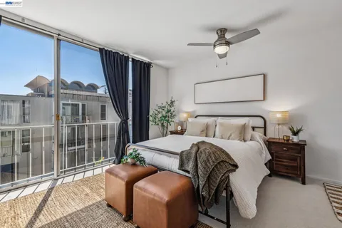 a bedroom with bed and a large window