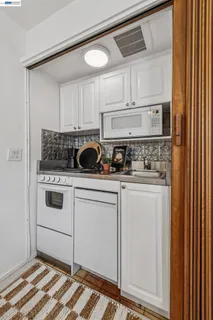 a kitchen with white cabinets and white appliances