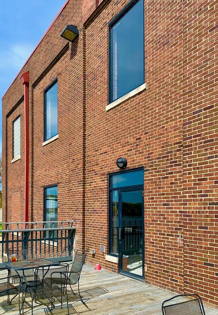 330 Southwest Water Street Peoria, IL 61602 - Photo 5 of 17 a view of a patio with a table and chairs