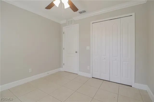 an empty room with a ceiling fan