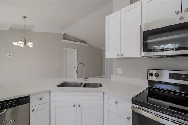 a kitchen with a sink stainless steel appliances and cabinets