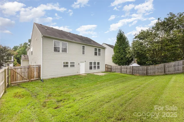 a view of a house with a yard and sitting area