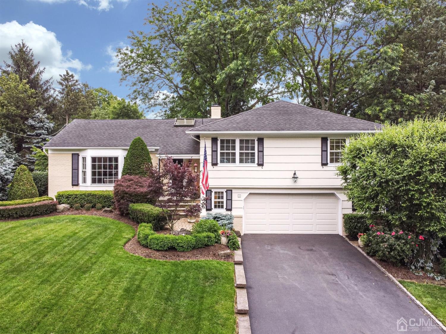 4 Moraine Road Edison, NJ 08820 - Photo 1 of 57 a front view of a house with a yard and garage