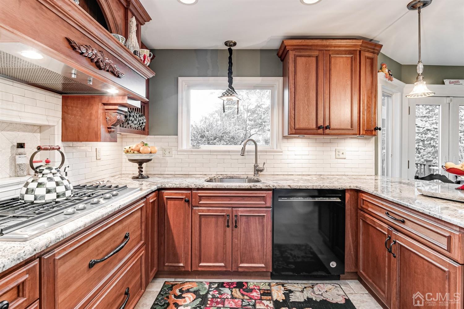 4 Moraine Road Edison, NJ 08820 - Photo 17 of 57 a kitchen with kitchen island granite countertop a sink stove and cabinets