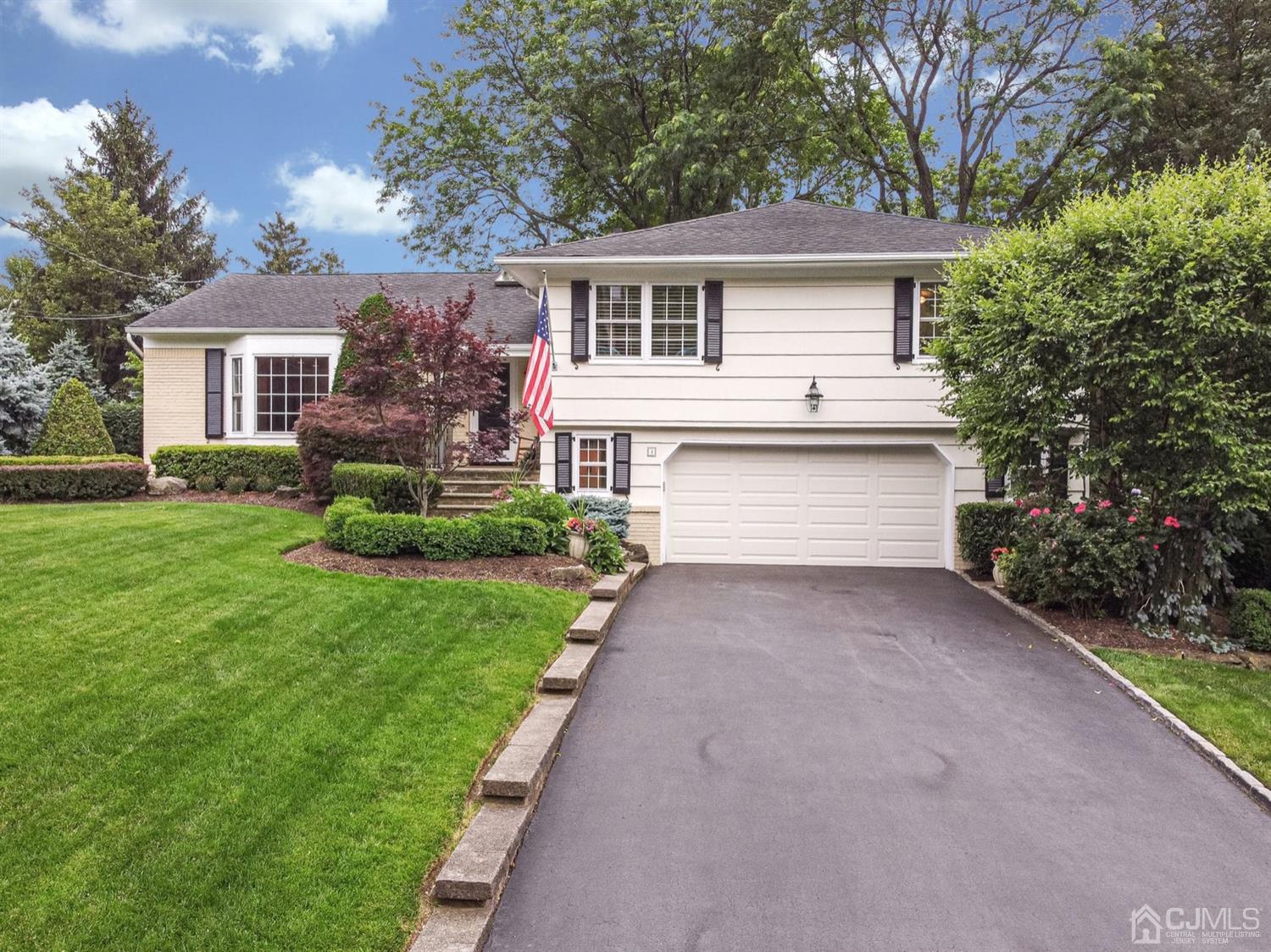 4 Moraine Road Edison, NJ 08820 - Photo 3 of 57 a front view of a house with a garden and yard