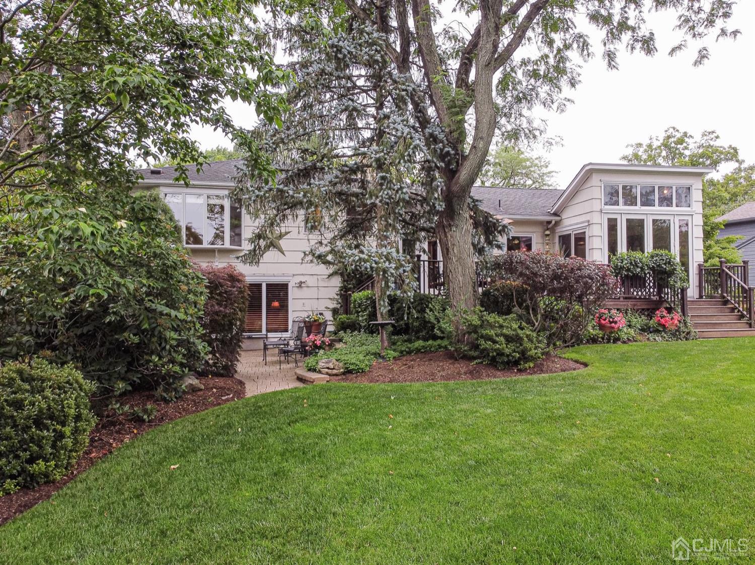 4 Moraine Road Edison, NJ 08820 - Photo 42 of 57 a front view of a house with a garden and sitting area