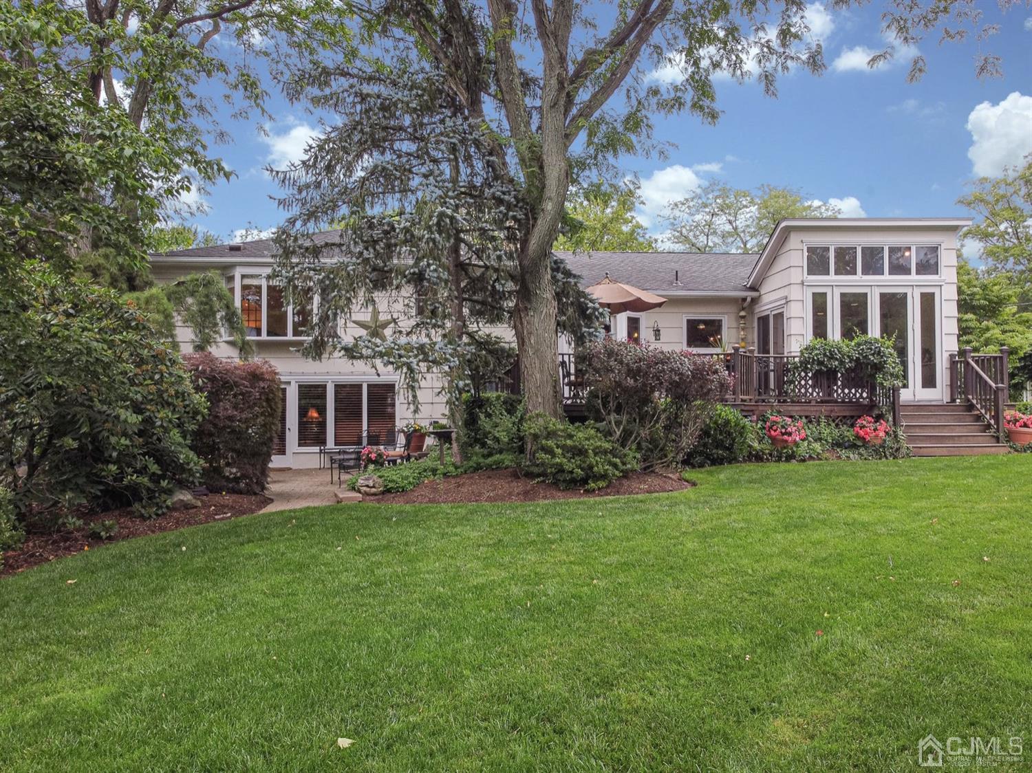 4 Moraine Road Edison, NJ 08820 - Photo 43 of 57 a front view of a house with a garden and trees