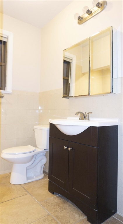 75 Elm Street Watertown, MA 02472 - Photo 10 of 12 a bathroom with a sink vanity mirror and toilet
