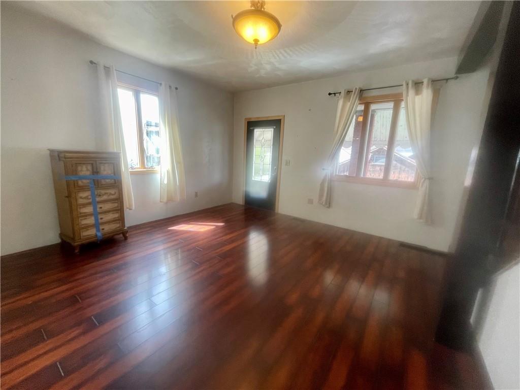 634 Ridge Avenue Ford City, PA 16226 - Photo 6 of 15 an empty room with wooden floor and windows