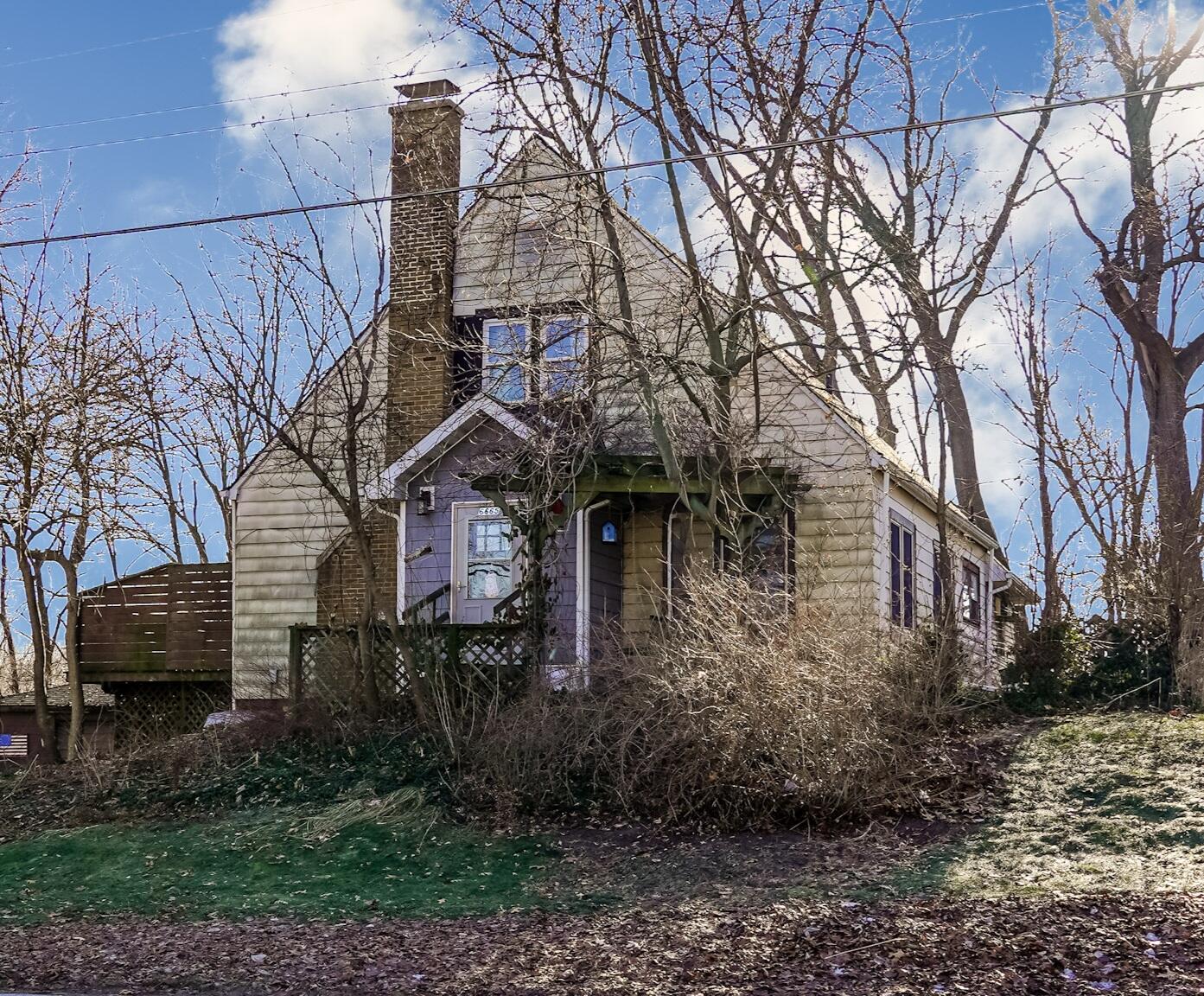 6665 Old Porter Road Portage, IN 46368 - Photo 1 of 20 a front view of a house with yard and trees