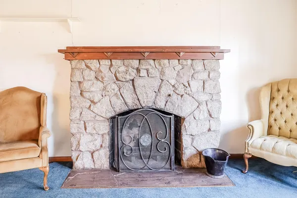 a large bed sitting in a room next to a window
