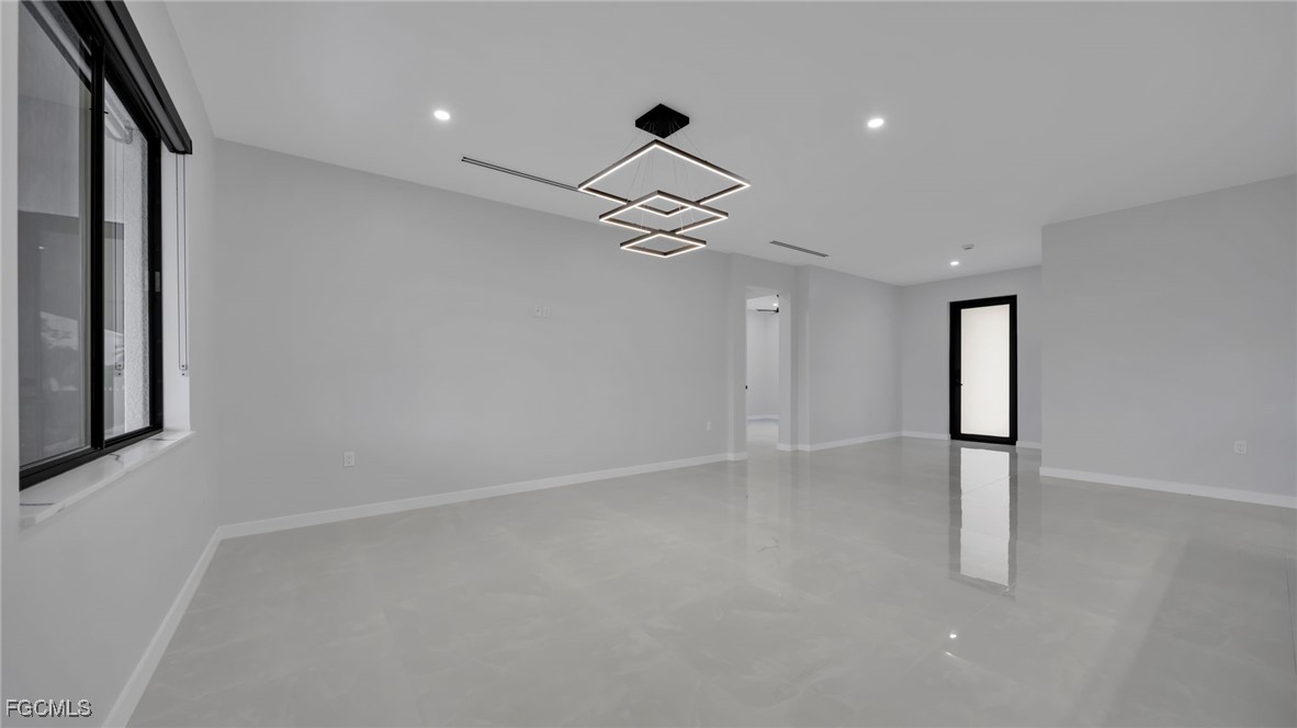 910 Northwest 36th Place Cape Coral, FL 33993 - Photo 18 of 46 wooden floor in an empty room with a window