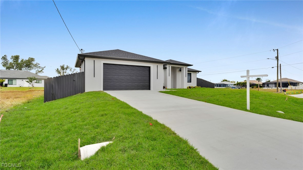 910 Northwest 36th Place Cape Coral, FL 33993 - Photo 2 of 46 a view of a house with backyard and garden