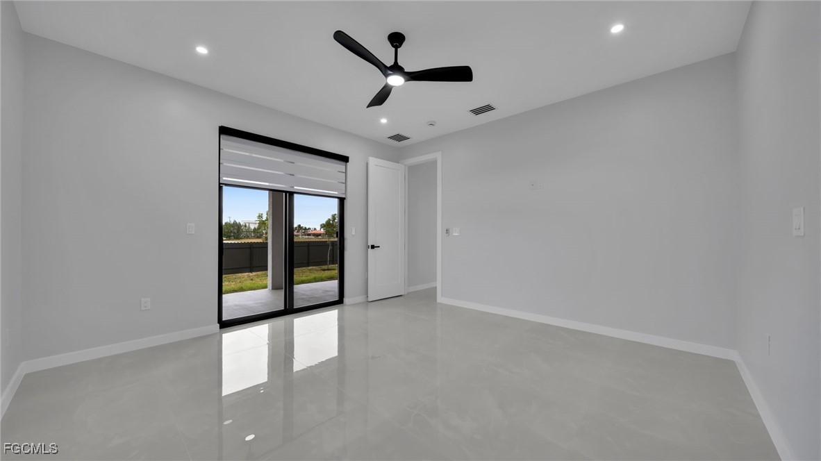 910 Northwest 36th Place Cape Coral, FL 33993 - Photo 21 of 46 an empty room with ceiling fan and windows