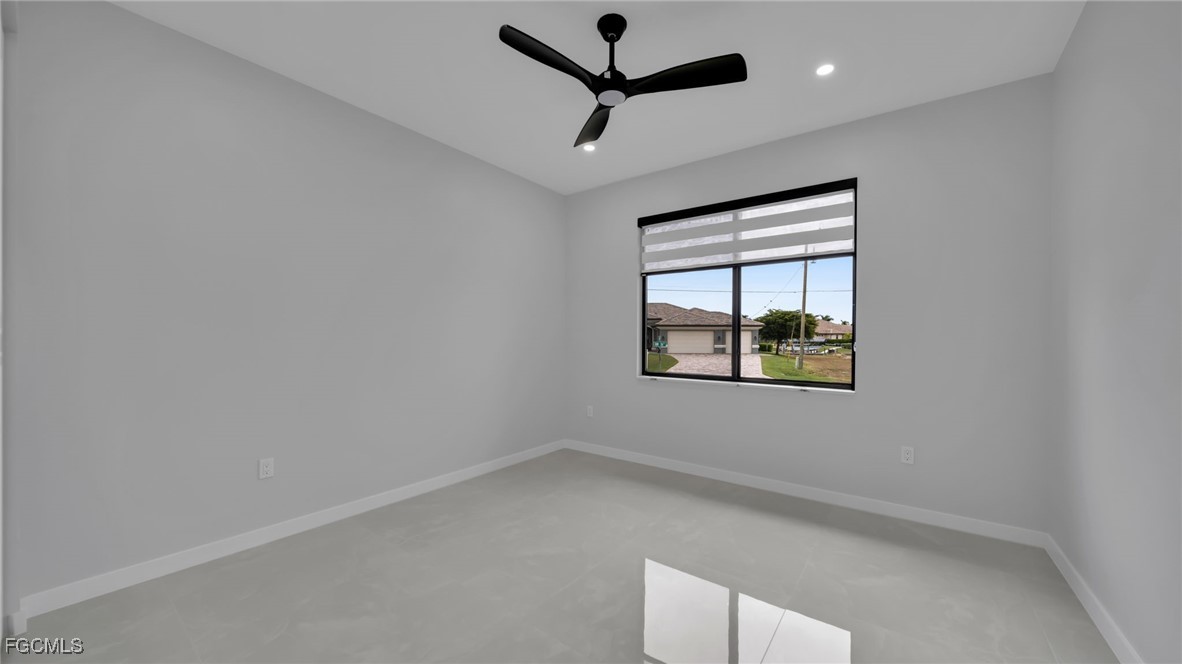 910 Northwest 36th Place Cape Coral, FL 33993 - Photo 28 of 46 an empty room with a window and a ceiling fan