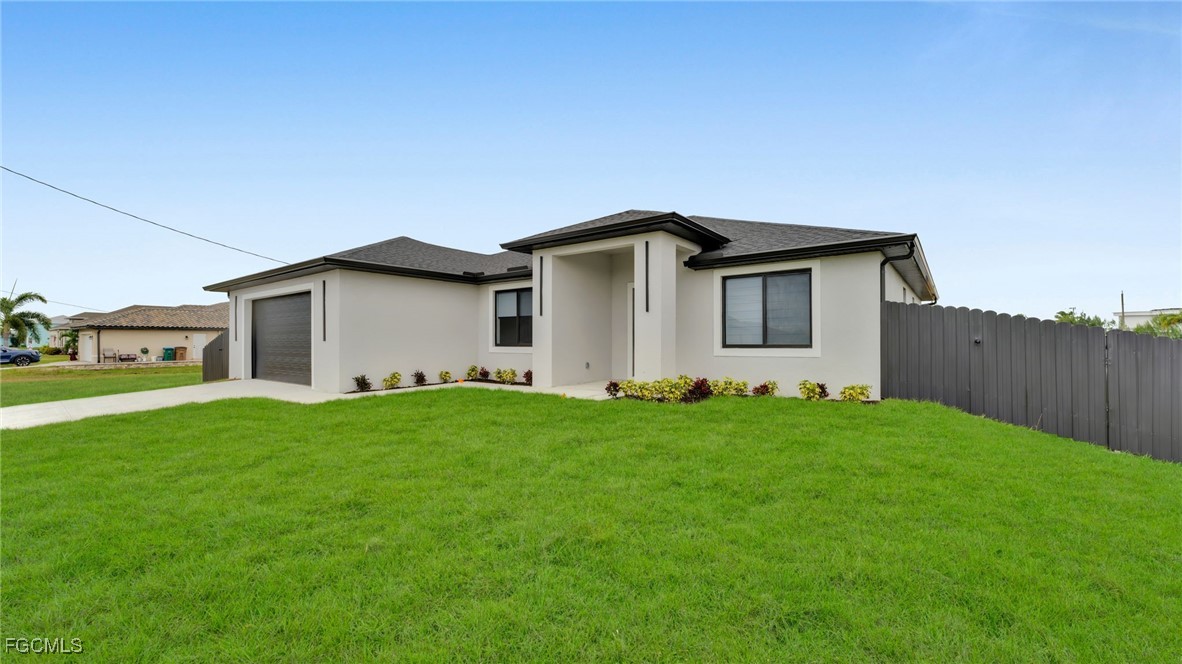 910 Northwest 36th Place Cape Coral, FL 33993 - Photo 3 of 46 a house with green field in front of it