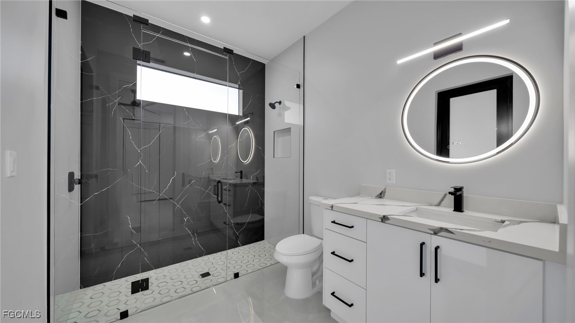 910 Northwest 36th Place Cape Coral, FL 33993 - Photo 33 of 46 a bathroom with a sink a toilet and shower