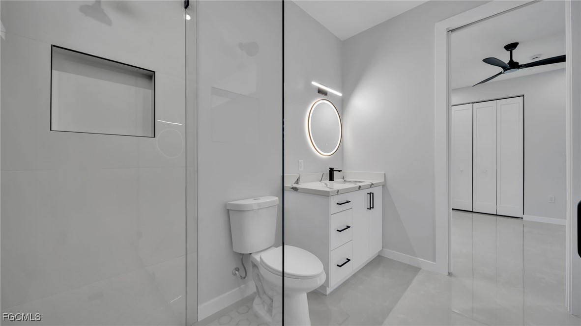 910 Northwest 36th Place Cape Coral, FL 33993 - Photo 34 of 46 a bathroom with a toilet sink vanity and mirror