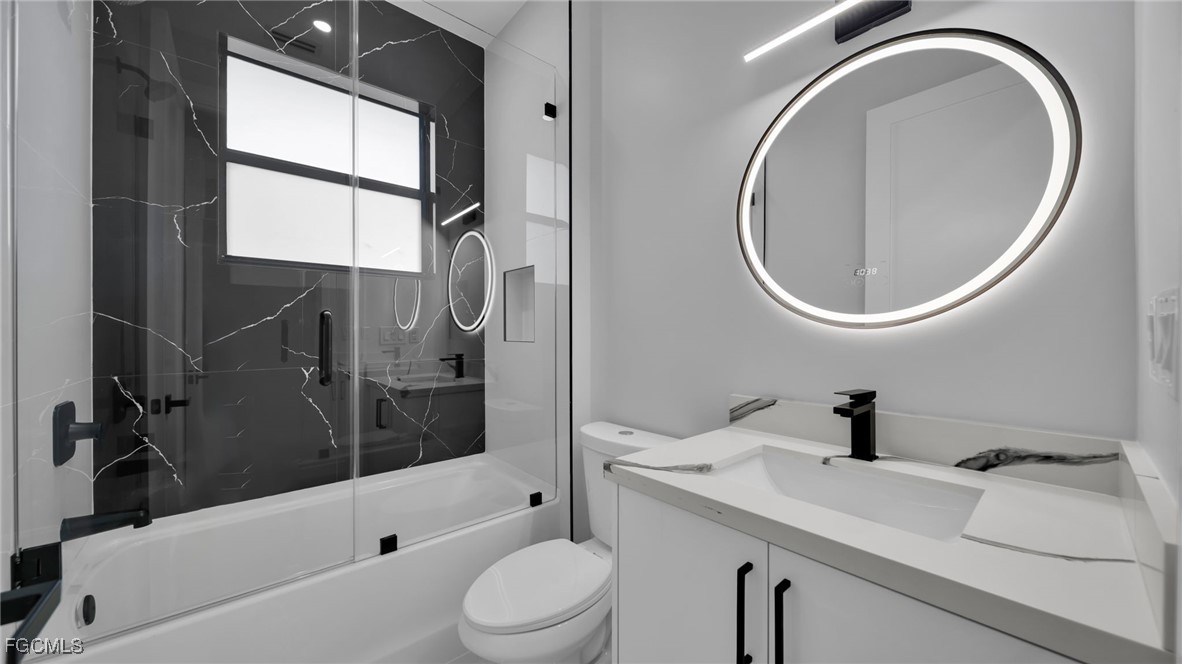 910 Northwest 36th Place Cape Coral, FL 33993 - Photo 35 of 46 a bathroom with a sink a toilet and a mirror