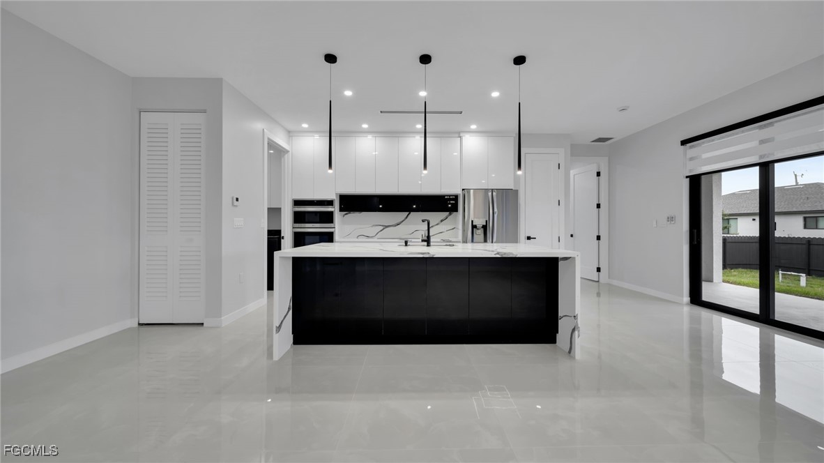 910 Northwest 36th Place Cape Coral, FL 33993 - Photo 9 of 46 a bathroom with a sink double vanity and a shower