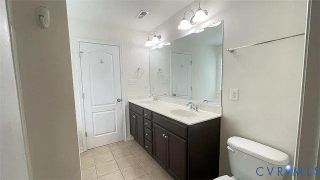 a bathroom with a toilet a sink a mirror and a shower