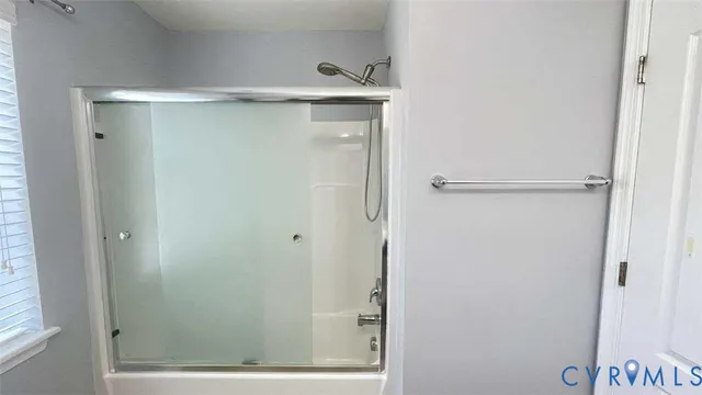 a bathroom with a glass shower door