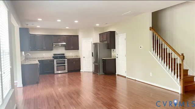 a kitchen with stainless steel appliances a refrigerator and a stove top oven