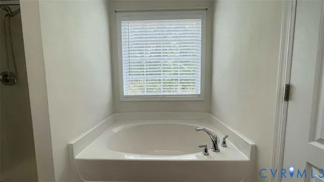 a white bath tub sitting next to a window