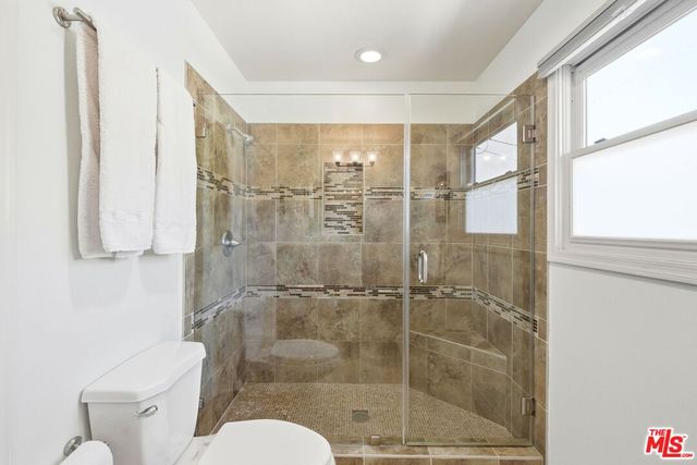 a bathroom with a shower and toilet