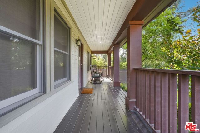 a view of balcony with couch and wooden floor