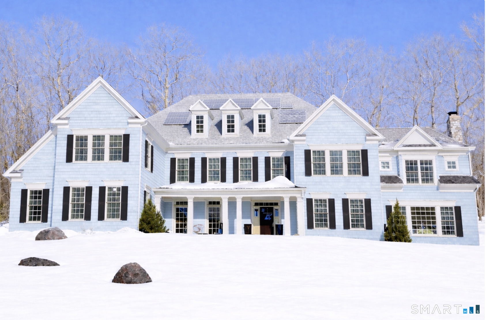 a front view of a building with a garden