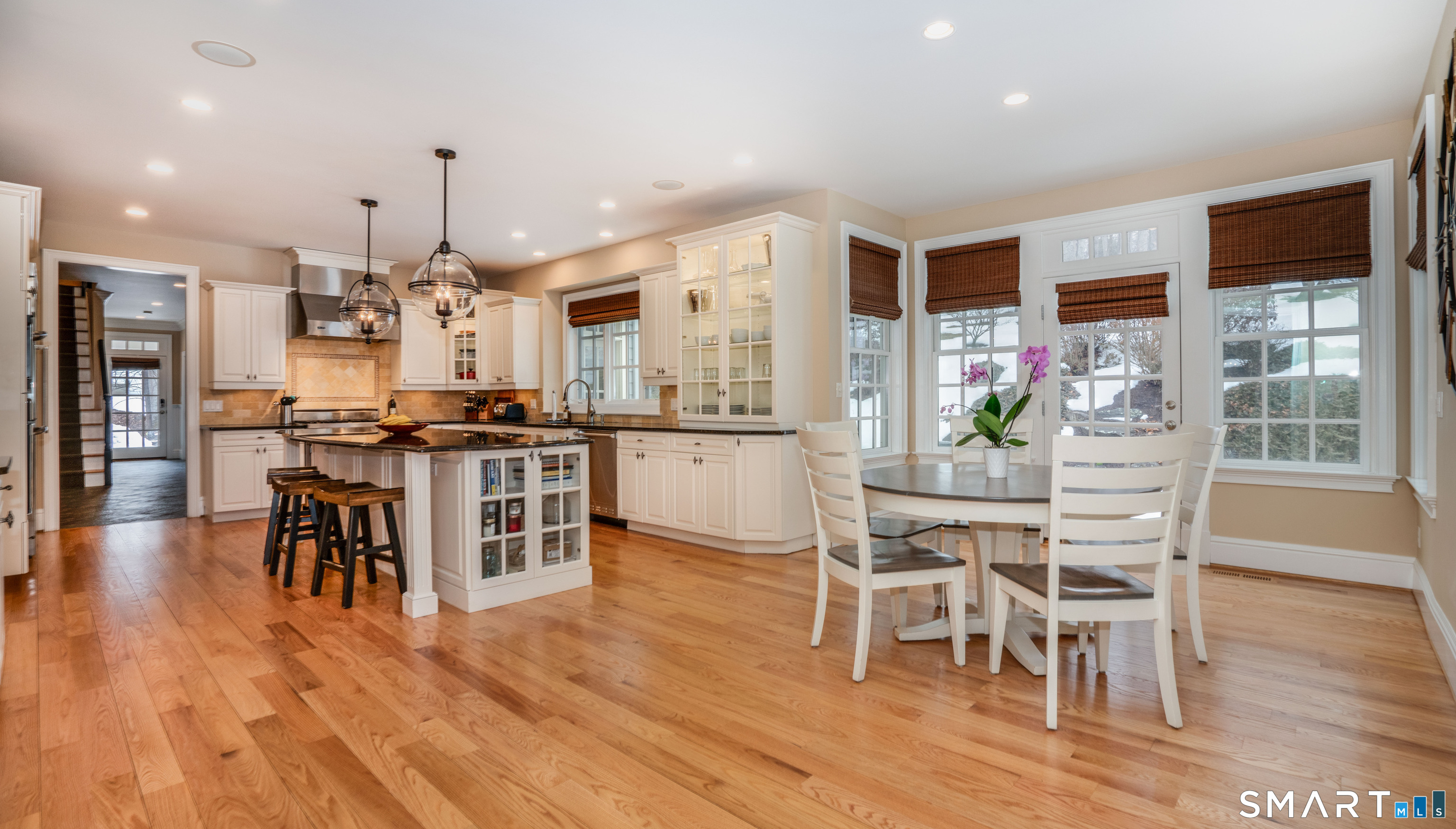 51 Westland Road Avon, CT 06001 - Photo 14 of 48 a kitchen with stainless steel appliances a dining table chairs stove and white cabinets