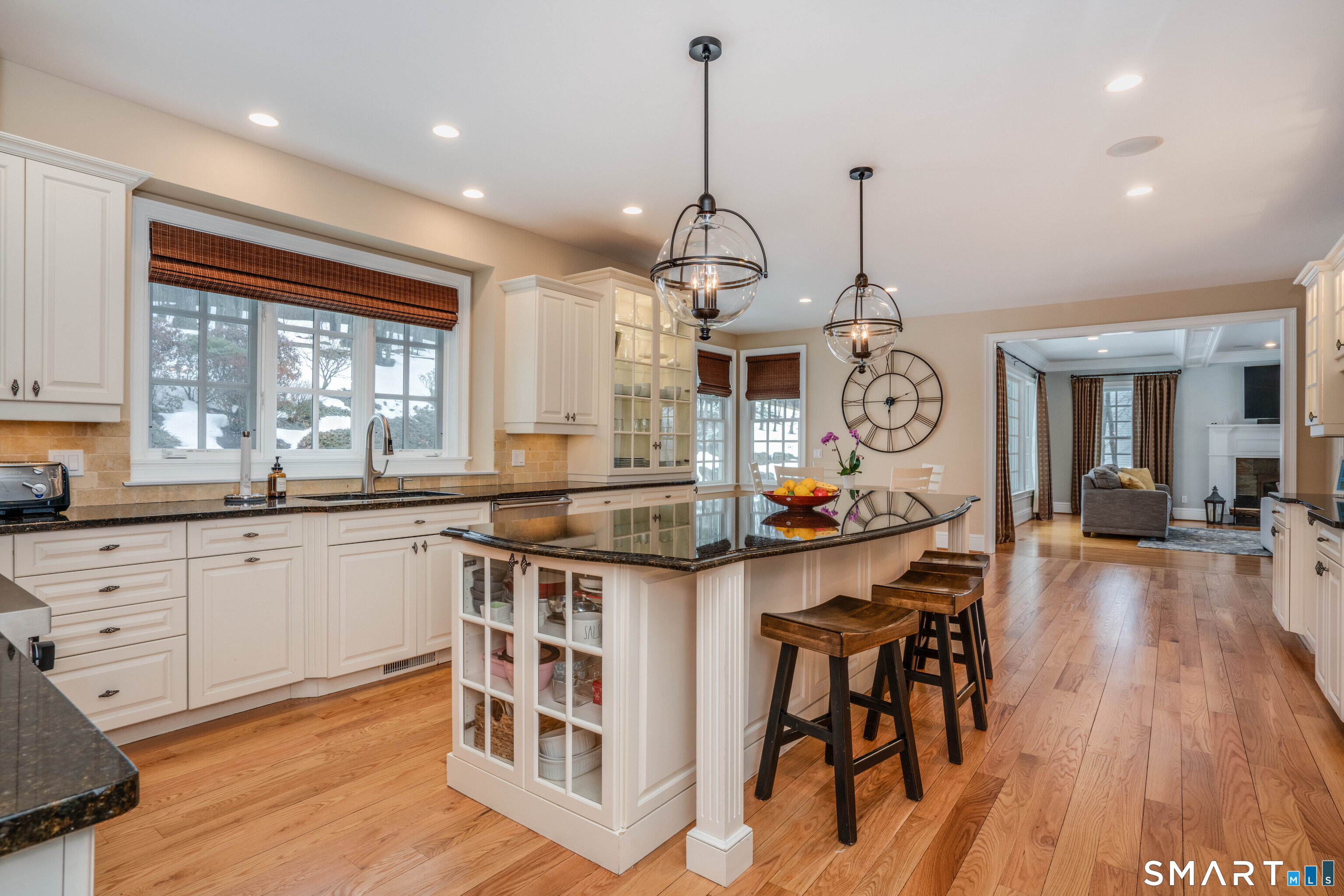 51 Westland Road Avon, CT 06001 - Photo 16 of 48 a kitchen with stainless steel appliances granite countertop a stove top oven a sink dishwasher a dining table and chairs with wooden floor