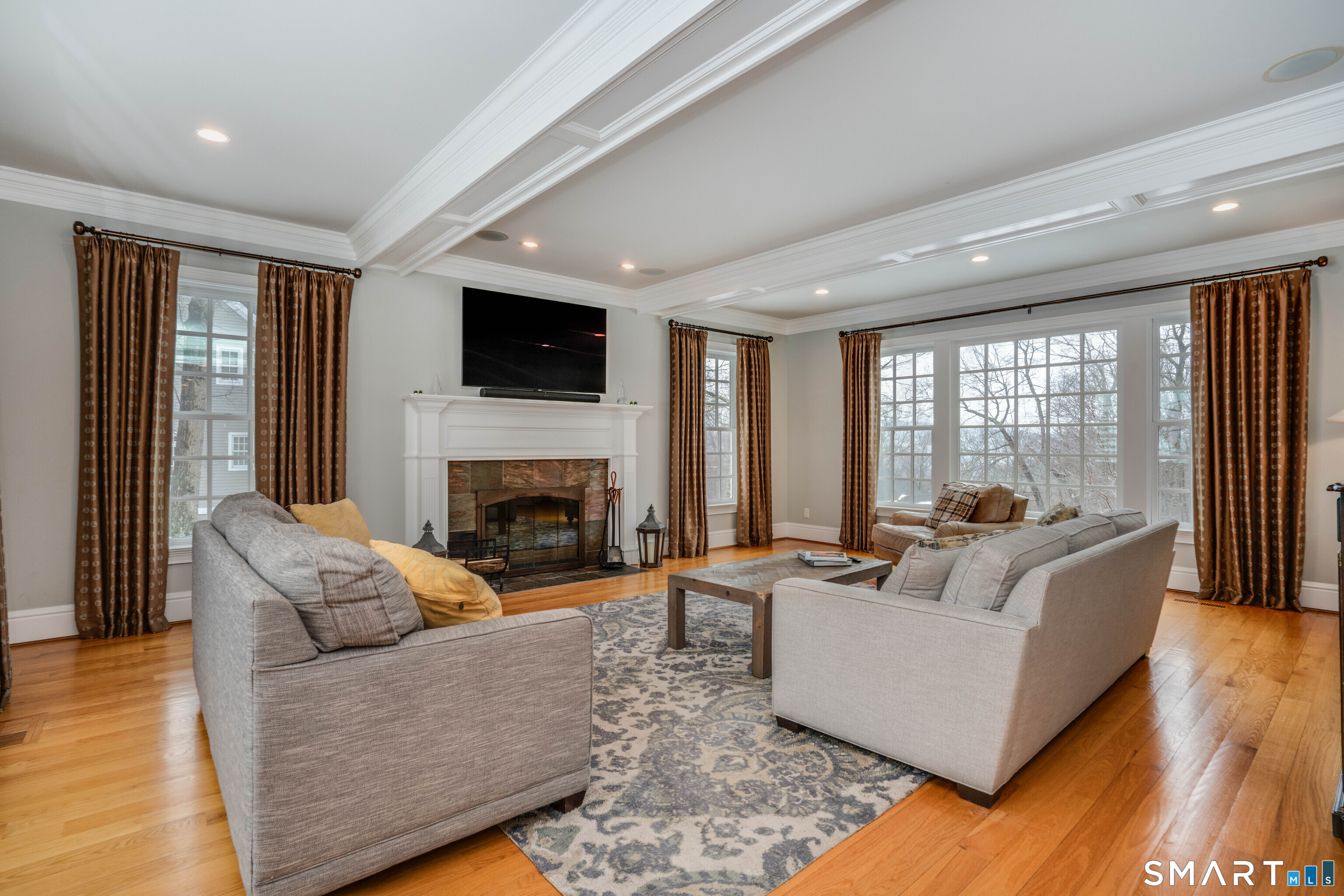 51 Westland Road Avon, CT 06001 - Photo 19 of 48 a living room with furniture a flat screen tv and a fireplace