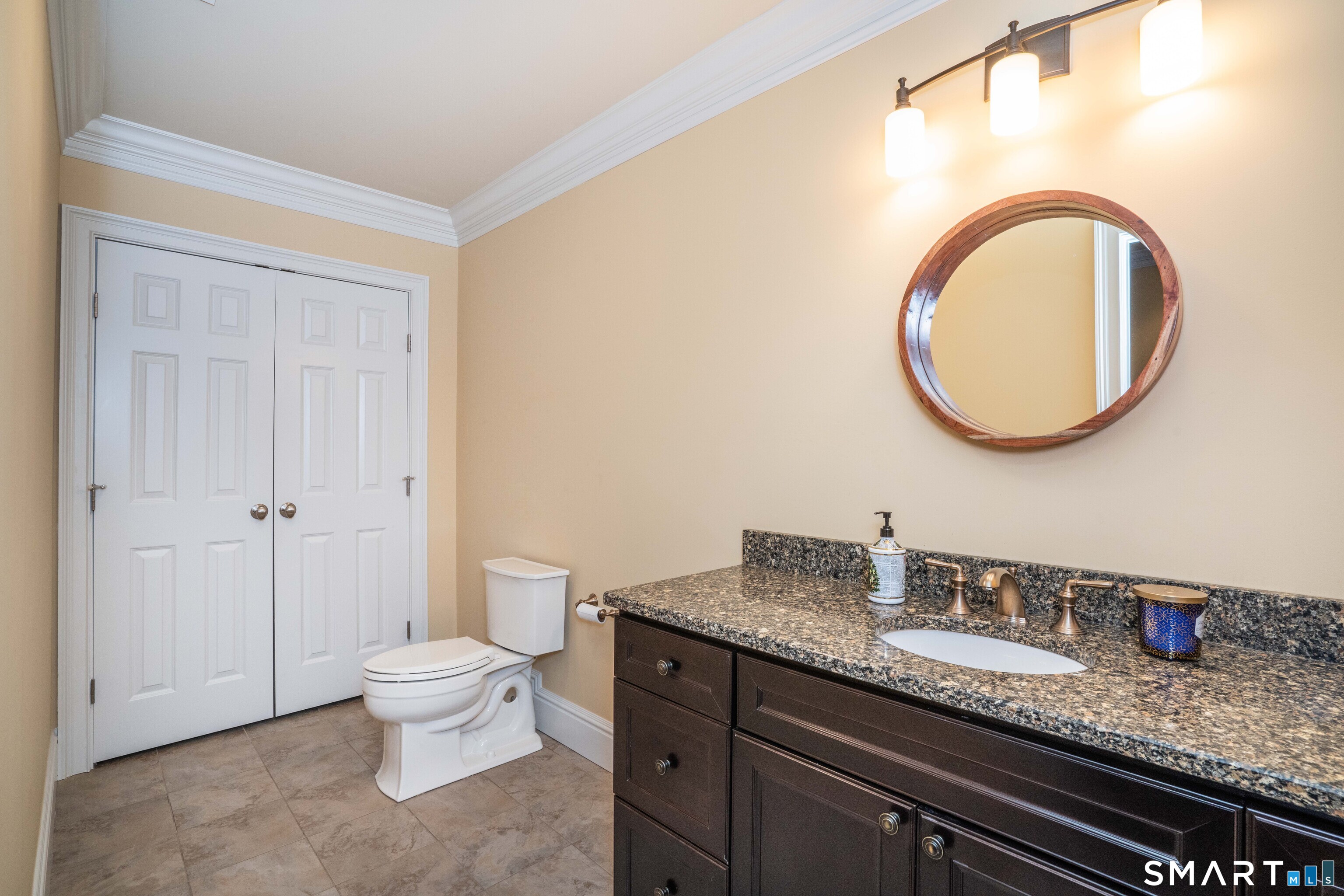 51 Westland Road Avon, CT 06001 - Photo 40 of 48 a bathroom with a granite countertop toilet a sink and a mirror