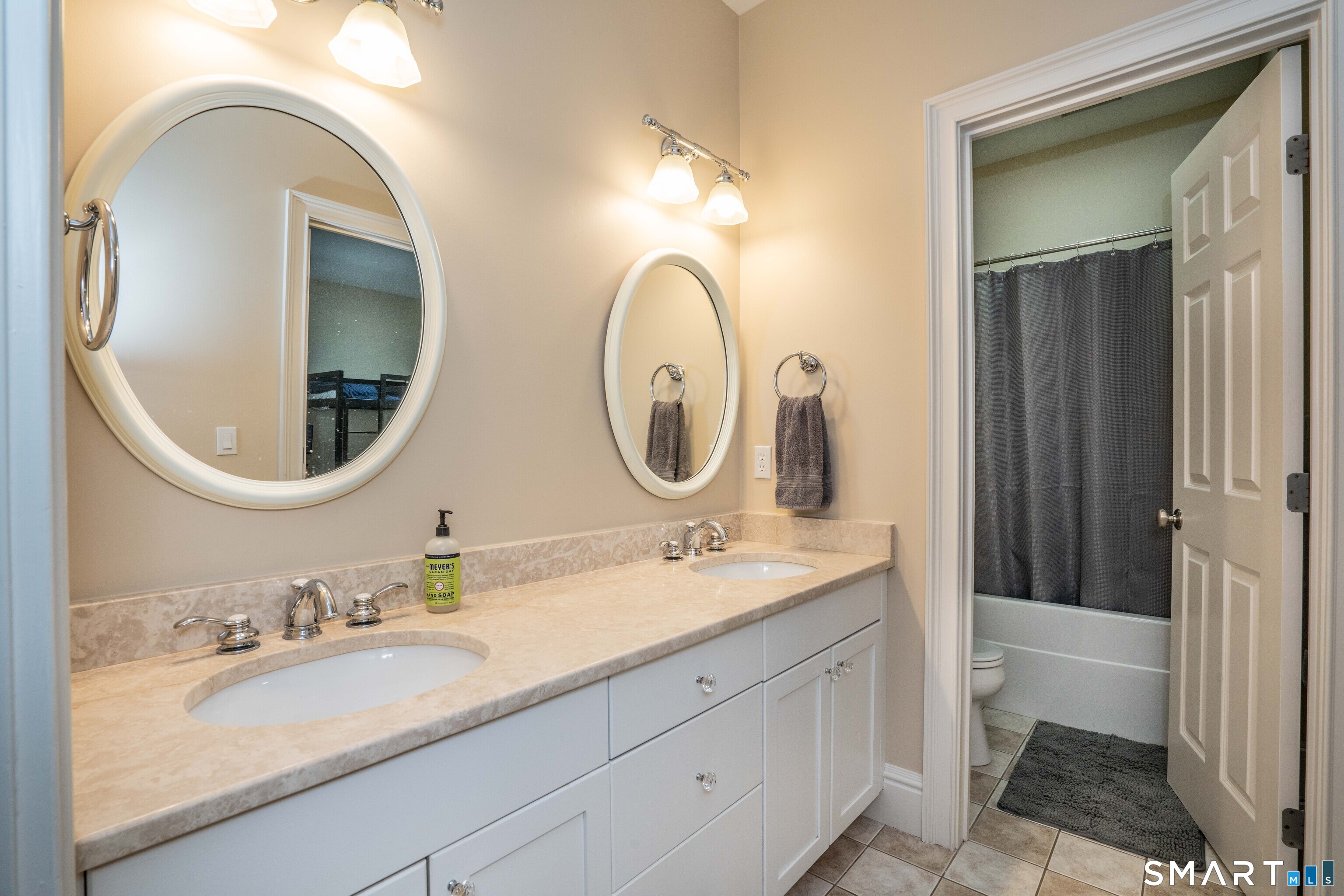 51 Westland Road Avon, CT 06001 - Photo 4 of 48 a bathroom with a granite countertop toilet a sink and a mirror