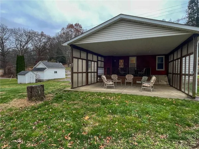 a backyard of a house with table and chairs
