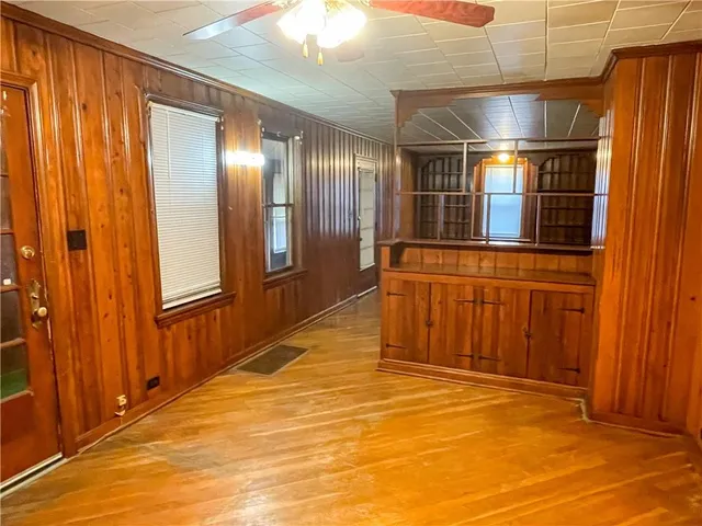 a view of a hallway with stainless steel appliances