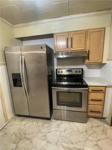 a kitchen with granite countertop white cabinets and stainless steel appliances